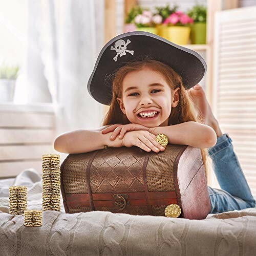 Girl dressed as a pirate with a treasure chest and gold coins.