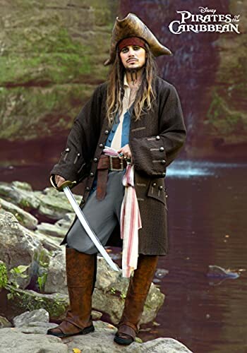 Person dressed as a pirate with a sword near a rocky stream.