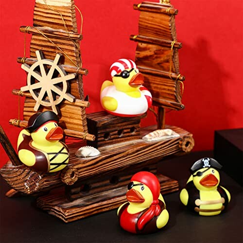 Pirate-themed rubber ducks on a wooden ship model.