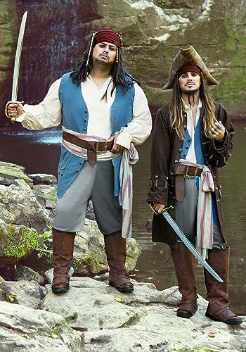 Two people dressed as pirates standing on rocks near water.